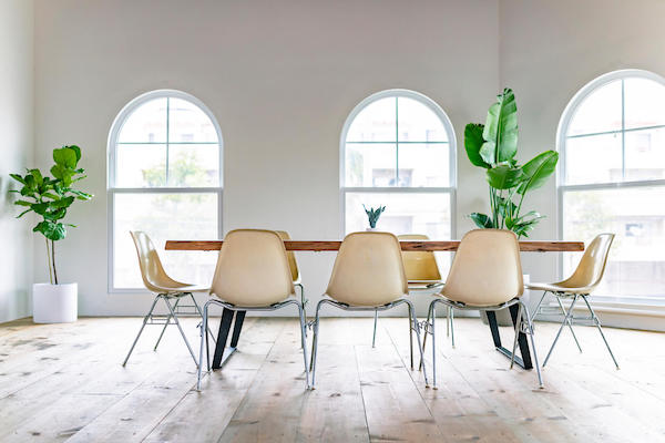 Modern office conference room with arched windows and indoor plant